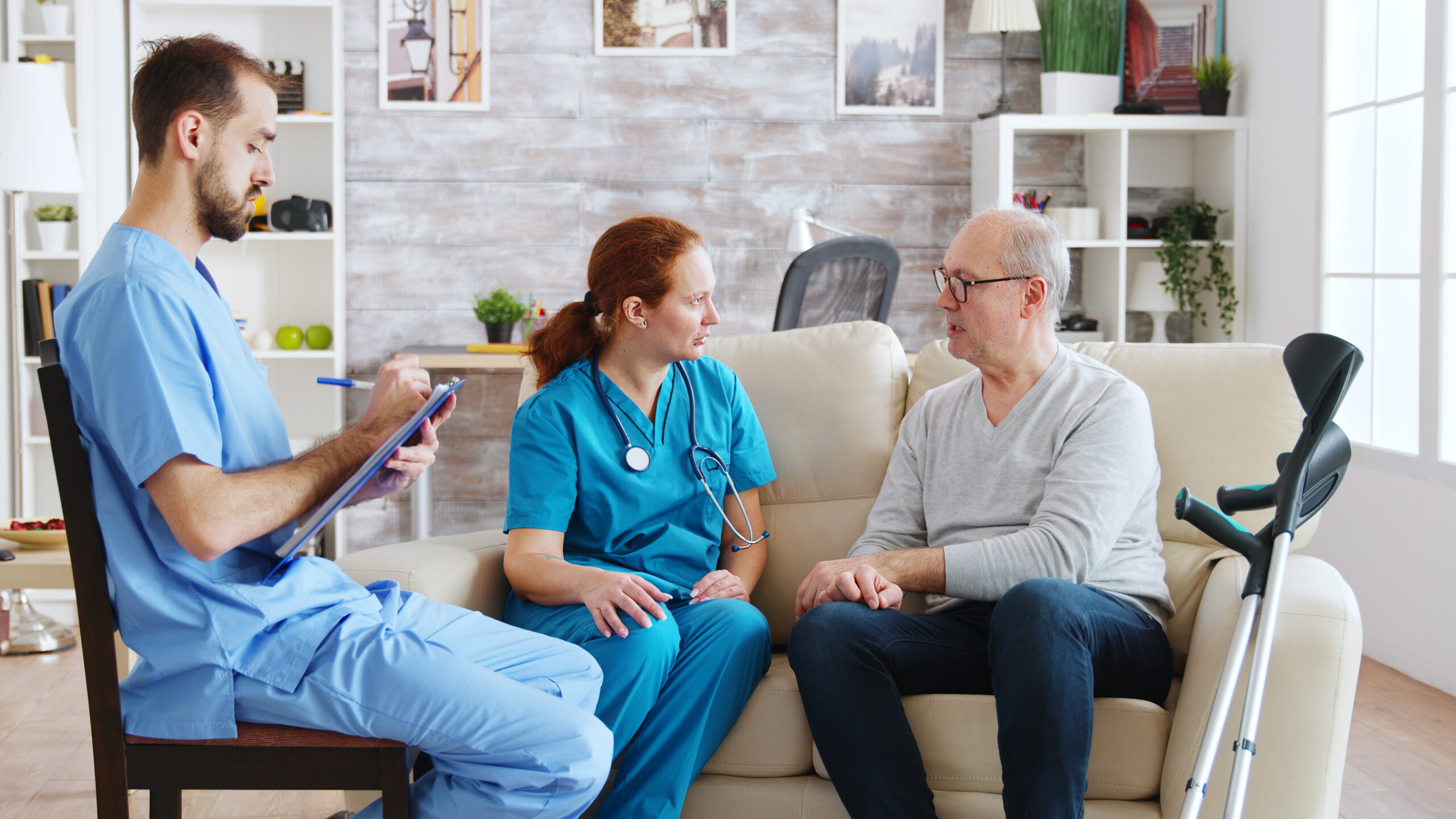 Nursing team discussing care options with an elderly patient